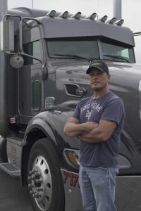 Man standing by truck.