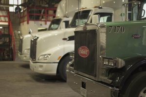 Sideview of trucks in garage.