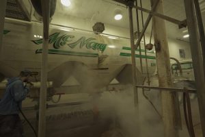 Truck getting cleaned in cleaning facility.